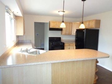 Park Forest house for rent - a kitchen with a sink and a black refrigerator