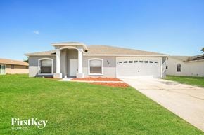 Poinciana house for rent - a house with a lawn and a driveway