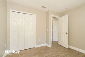 Poinciana house for rent - a bedroom with two doors and a door to a closet