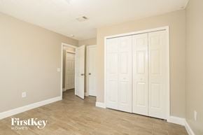Poinciana house for rent - the living room and hallway of a house with white doors