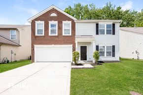 Indianapolis house for rent - A two-story house with a brick facade and a white garage door.