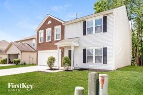 Indianapolis house for rent - A house with a white garage door and a brick chimney.