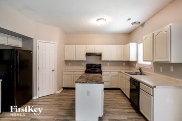 Indianapolis house for rent - A kitchen with white cabinets and appliances.