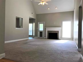 Helena house for rent - A spacious living room with a fireplace and a ceiling fan.