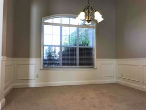 Helena house for rent - A room with a large window and a chandelier.