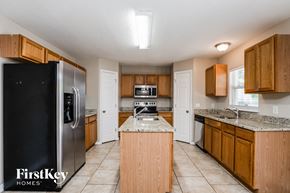 Palm Bay house for rent - a kitchen with wooden cabinets and a stainless steel refrigerator