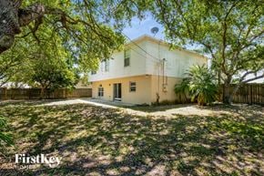 Palm Bay house for rent - a white house with a yard and trees