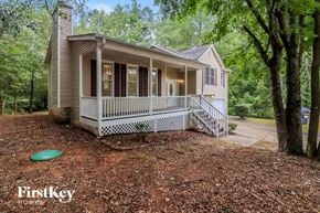 Dallas house for rent - a small house with a porch and a frisbee on the ground