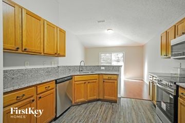 St. Augustine house for rent - A kitchen with wooden cabinets and a granite countertop.