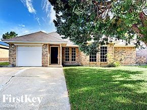 Arlington house for rent - a small brick house with a white garage door