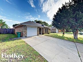 Arlington house for rent - a small brick house with a driveway and a tree