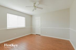 Spring house for rent - a bedroom with wood floors and a ceiling fan