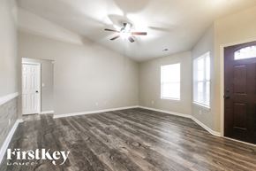 Indianapolis house for rent - A room with wooden flooring and a ceiling fan.
