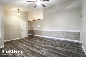 Indianapolis house for rent - A room with wooden flooring and a ceiling fan.