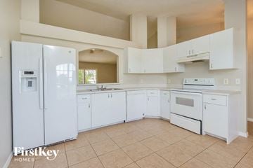Port St. Lucie house for rent - a white kitchen with white appliances and white cabinets