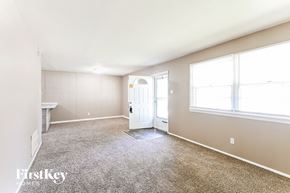 Hazelwood house for rent - an empty living room with a white door and a window