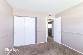 Hazelwood house for rent - a bedroom with white closets and a carpeted floor