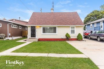 Round Lake Beach house for rent - a white house with a lawn and a driveway