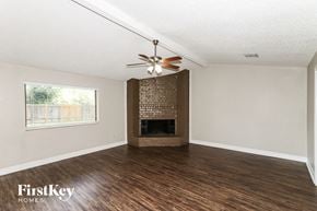 Richmond house for rent - A room with a fireplace and a ceiling fan.