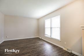 Kansas City house for rent - the living room of a home with wood flooring and a large window