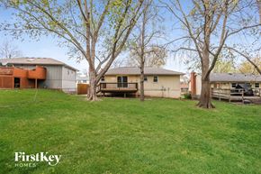 Kansas City house for rent - a backyard with some trees and a house