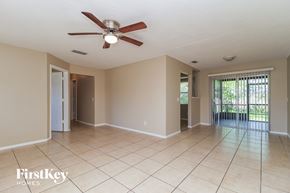 Deltona house for rent - A spacious room with a ceiling fan and tiled floor.