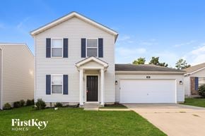 Wentzville house for rent - A white house with a black door and a garage door.