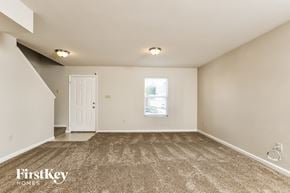 Wentzville house for rent - A room with a carpeted floor and a white door.