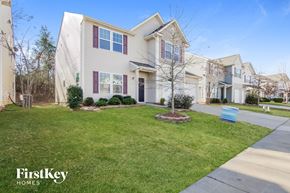 Charlotte house for rent - a home with a lawn and a sidewalk in front of it