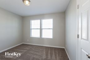 Charlotte house for rent - a bedroom with a carpeted floor and two windows