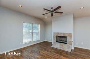 Lancaster house for rent - a living room with a fireplace and a ceiling fan