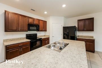 Cape Coral house for rent - a kitchen with granite counter tops and black appliances