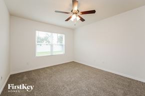 Cape Coral house for rent - a living room with a ceiling fan and a window