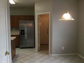 Desoto house for rent - an empty kitchen with a stainless steel refrigerator  and a light