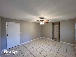 Port Charlotte house for rent - A room with a ceiling fan and tile flooring.
