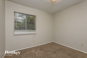 Apopka house for rent - the living room of a house with a window and carpet