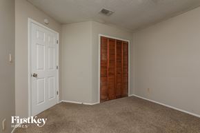 Apopka house for rent - a bedroom with carpet and a door to a closet