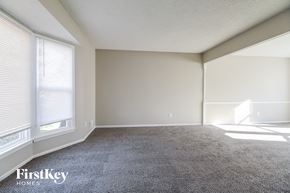 Belton house for rent - an empty living room with carpet and two windows