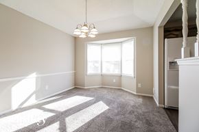 Belton house for rent - an empty living room with carpet and a large window