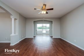 Valrico house for rent - A spacious room with a ceiling fan and wooden flooring.