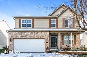 Indianapolis house for rent - a house with a white garage door in the snow