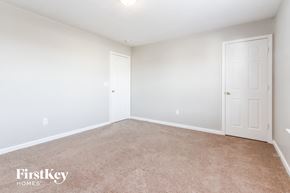 Indianapolis house for rent - a bedroom with a carpeted floor and a white door