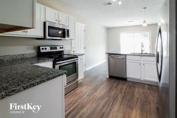 Summerville house for rent - a kitchen with granite counter tops and stainless steel appliances