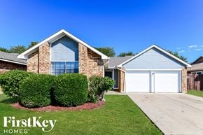Arlington house for rent - a brick house with a white garage door and a lawn
