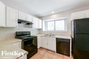 Arlington house for rent - a kitchen with black appliances and white cabinets