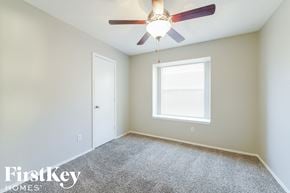 Arlington house for rent - a bedroom with a ceiling fan and a window