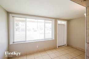 Hollywood house for rent - A room with a large window and a tiled floor.