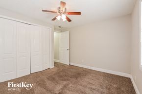 Apopka house for rent - a bedroom with carpet and a ceiling fan