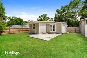 Apopka house for rent - a backyard with a shed and a grass yard and a fence