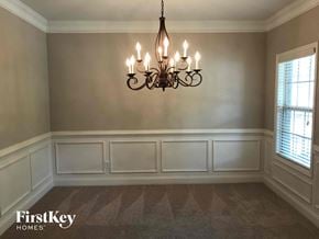Lawrenceville house for rent - a dining room with white wainscoting and a chandelier